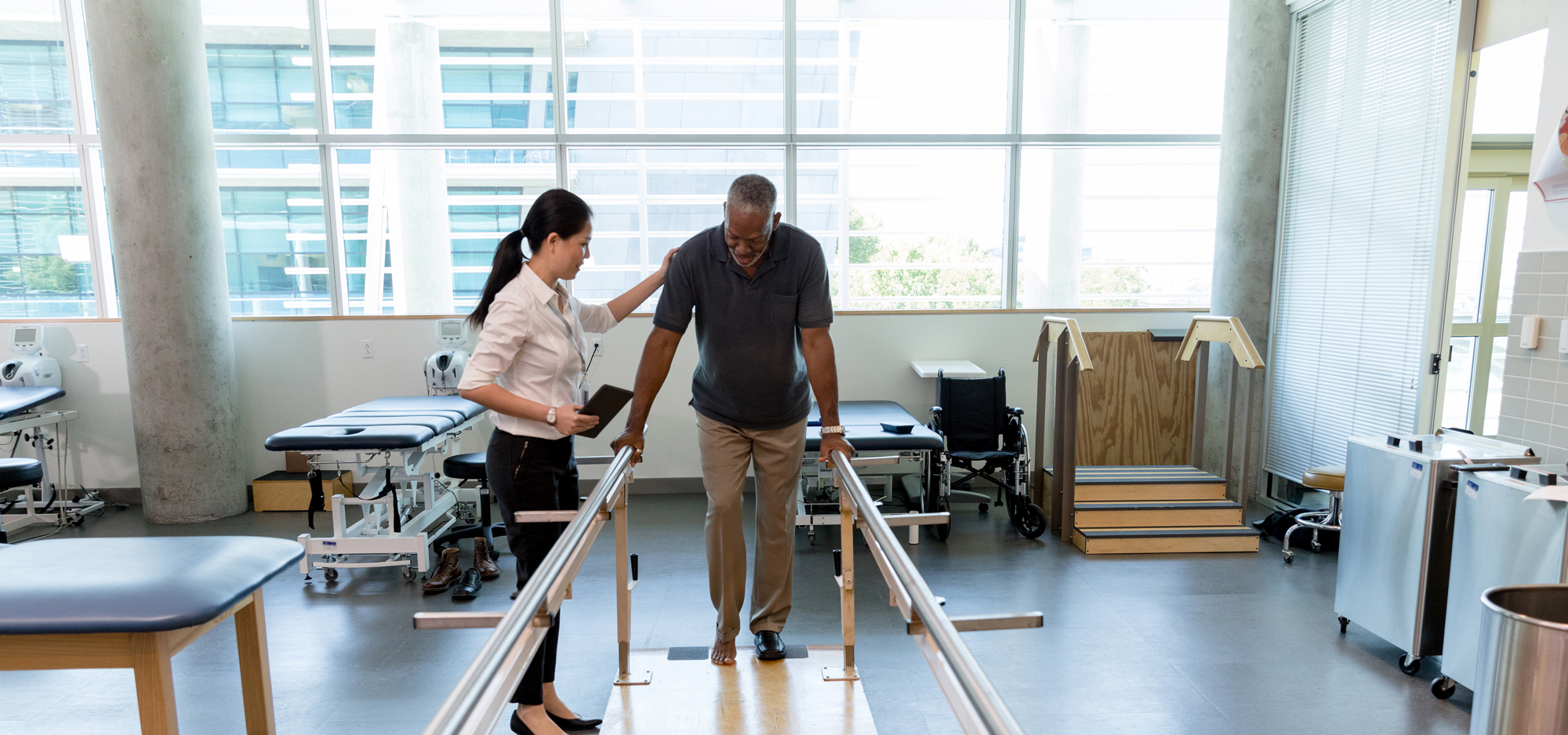 Physical therapist working with senior man